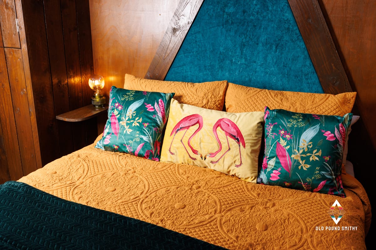Cosy bed with bright cushions in a yurt in the north devon countryside