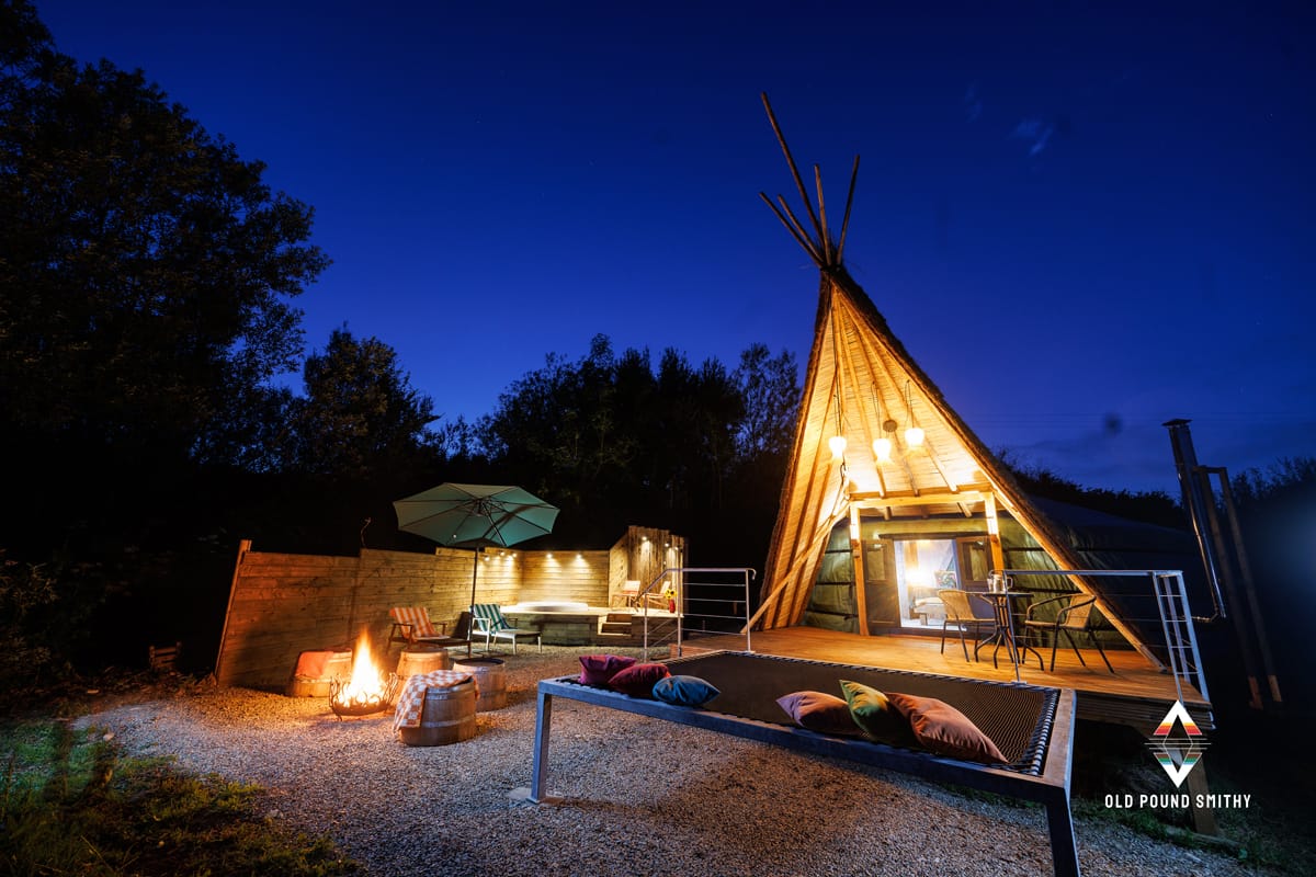 Warm fire pit burning in front of Yurt accommodation at dusk at Old Pound Smithy