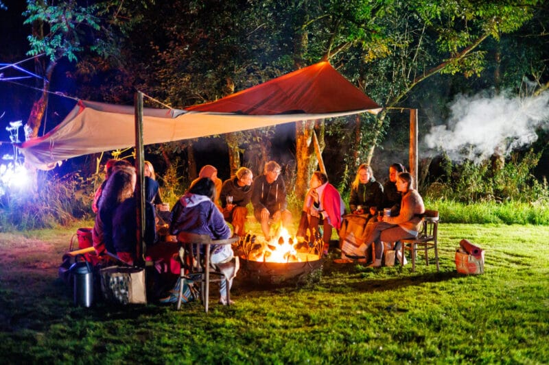 small group of people enjoying an evening fire together